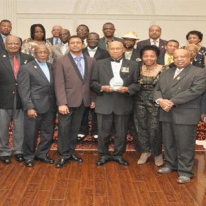 Colonel Cecil “Pluto” Martindale (centre), with gift, poses with members of the Guyana Ex-Soldiers of Canada (Photo Credit Guyana Chronicle)