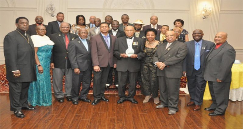 Colonel Cecil “Pluto” Martindale (centre), with gift, poses with members of the Guyana Ex-Soldiers of Canada (Photo Credit Guyana Chronicle)